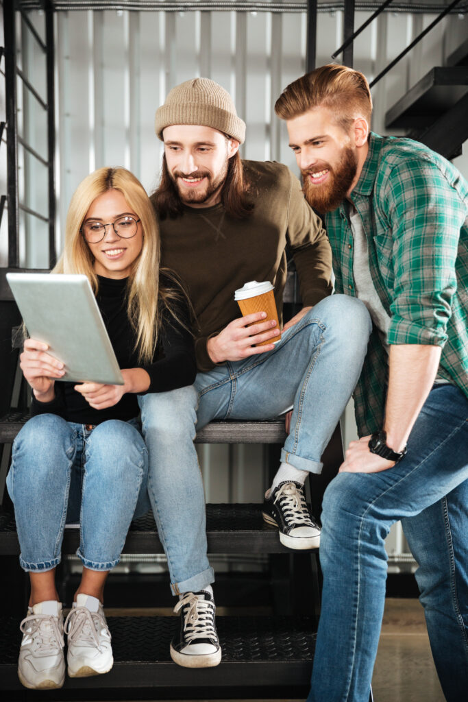 Colleagues in office using tablet computer.
