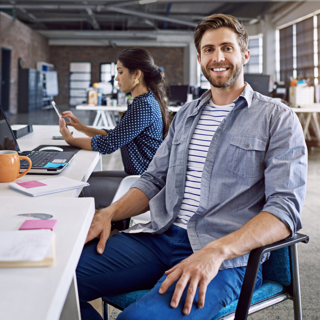 confidence-smile-portrait-man-desk-with-laptop-woman-creative-agency-working-project-together-leadership-collaboration-happy-employees-business-people-design-startup