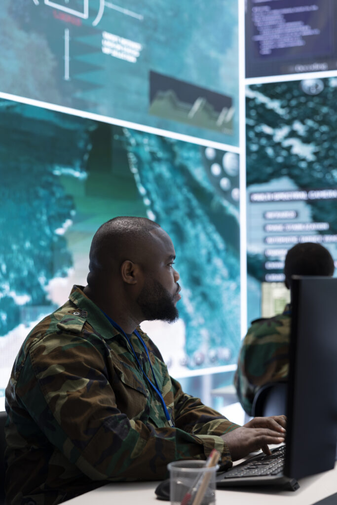 Government intelligence officers in a command post oversee satellite data