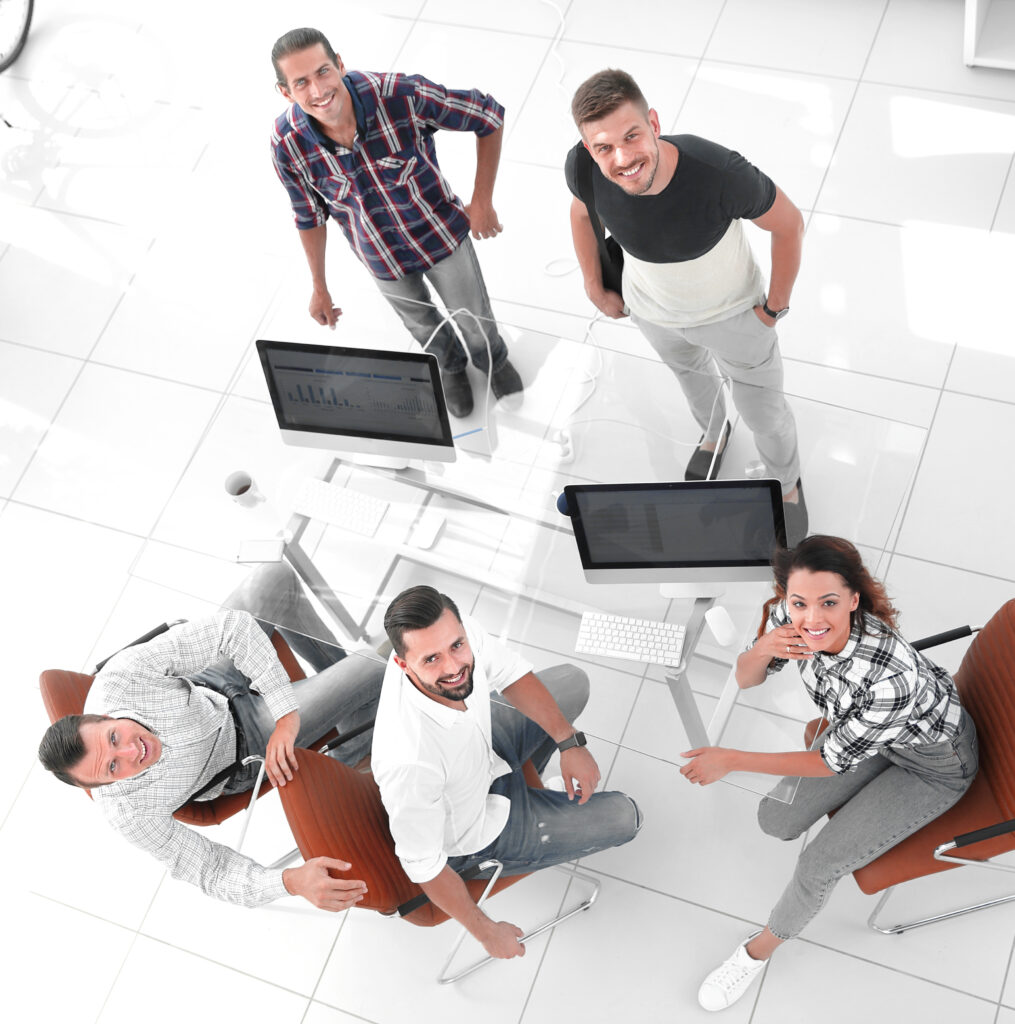 view the top creative team sitting behind a Desk